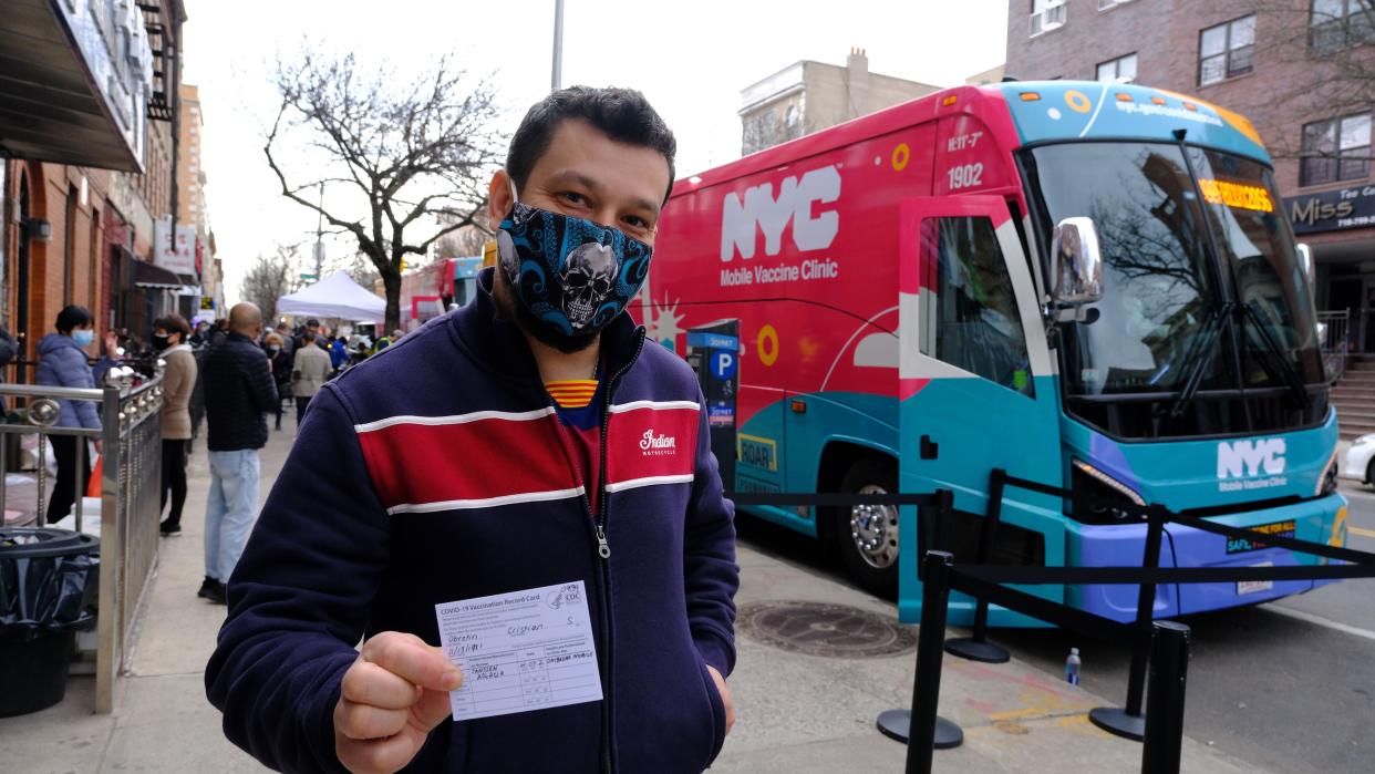 Cristian Obretin, a Peter Lugo Restaurant worker, displays his CDC Vaccination Card after being vaccinated on an NYC Mobile Vaccine Clinic bus parked on Seventh Ave. and 54th St. in Brooklyn early Wednesday, April 7, 2021.