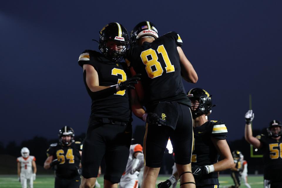 Southeast Polk's Carson Robbins, left, and Braden Lundgren celebrate a touchdown. The Rams are the second-ranked team in our midseason Super 10.