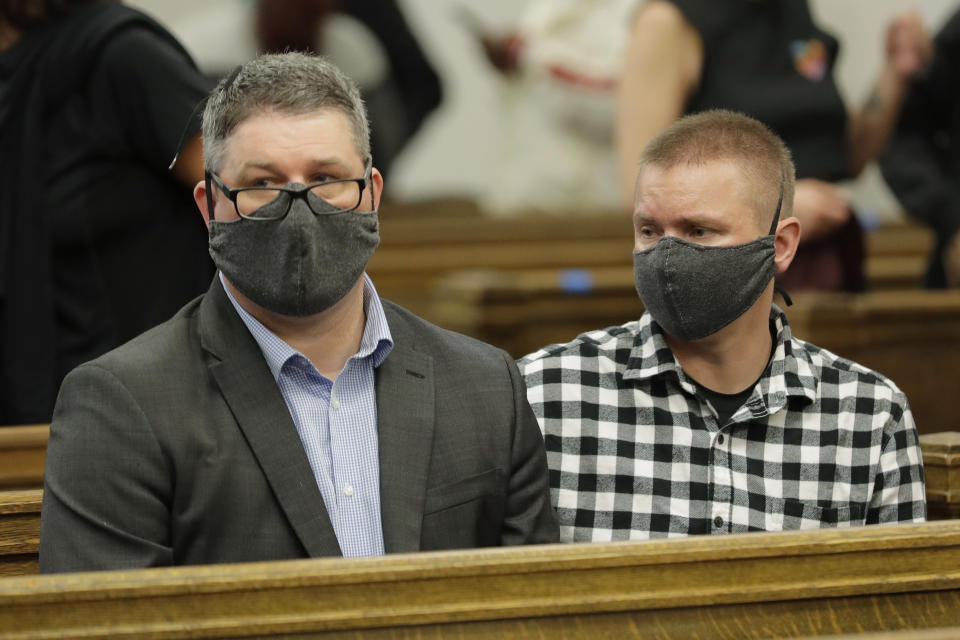 FILE - Matt Taylor, left, sits with his partner, Evan Haliburton, right, during the arraignment of Dawit Kelete in King County Superior Court, Wednesday, July 22, 2020, in Seattle. Taylor's child, Summer Taylor, was killed when they were hit by a car driven by Kelete, who is facing felony charges of vehicular homicide, vehicular assault and reckless driving. Kelete, who hit two protesters, killing one of them, with his car during a Black Lives Matter demonstration in Seattle in 2020 has pleaded guilty to multiple felonies. The Seattle Times reports 30-year-old Kelete pleaded guilty on Thursday, July 27, 2023, to vehicular homicide in the death of Summer Taylor. (AP Photo/Ted S. Warren, File)