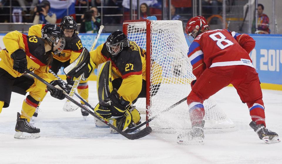 Iya Govrilova of Russia scores a goal past Goalkeeper Viona Harrer and Tanja Eisenschmid,left, of Germany during the third period of the 2014 Winter Olympics women's ice hockey game at Shayba Arena, Sunday, Feb. 9, 2014, in Sochi, Russia. AP Photo/Petr David Josek)