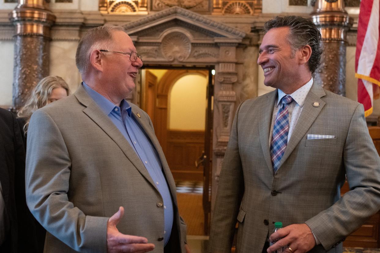 House Majority Leader Rep. Dan Hawkins, R-Wichita, left, speaks with Senate President Ty Masterson, R-Andover, right, during the final day of the 2022 legislative session Monday at the Statehouse.