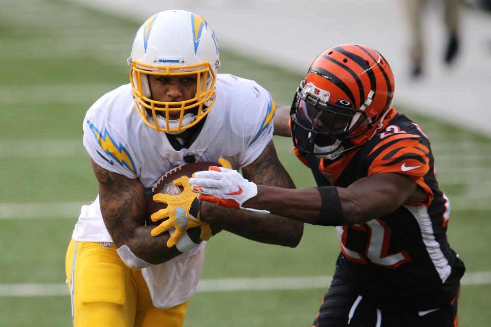 Los Angeles Chargers wide receiver Keenan Allen (13) turns upfield after making a catch as Cincinnati Bengals cornerback William Jackson (22) defends in the third quarter during a Week 1 NFL football game, Sunday, Sept. 13, 2020, at Paul Brown Stadium in Cincinnati. The Cincinnati Bengals lost 16-13. 