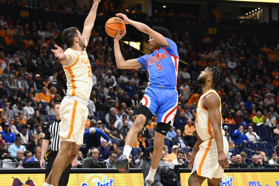 Mississippi guard James White (5) looks to pass as Tennessee guard Santiago Vescovi, left, and guard Josiah-Jordan James defend during the first half of an NCAA college basketball game in the second round of the Southeastern Conference Tournament, Thursday, March 9, 2023, in Nashville, Tenn. (AP Photo/John Amis)