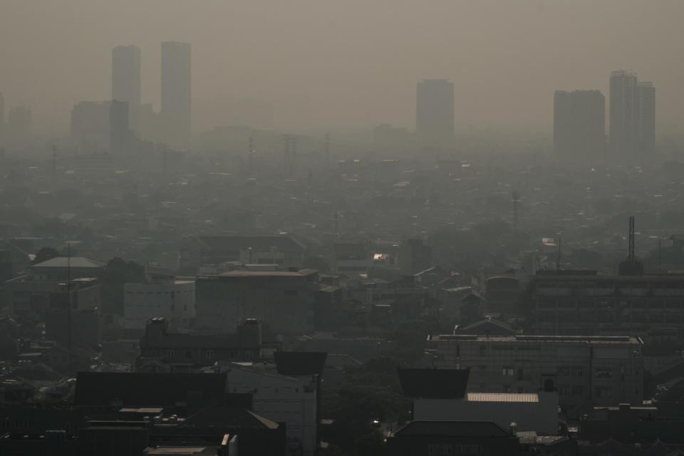 Buildings are seen in the haze caused by the air pollution in Jakarta, Indonesia, on August 16, 2023. / Credit: YASUYOSHI CHIBA/AFP via Getty Images