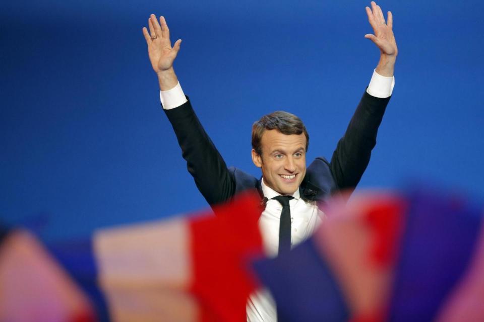 Front-runner: Emmanuel Macron waves before addressing his supporters (AP)