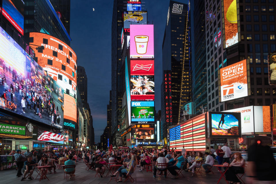 Billboards lit up in Times Square at dusk