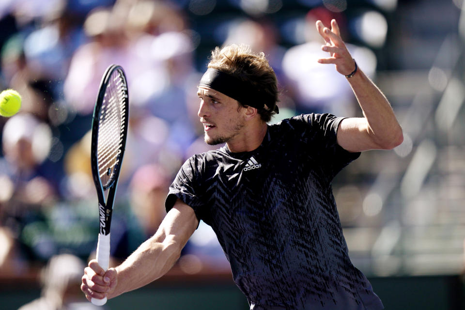 Alexander Zverev, of Germany, returns to Taylor Fritz, of the United States, at the BNP Paribas Open tennis tournament Friday, Oct. 15, 2021, in Indian Wells, Calif. (AP Photo/Mark J. Terrill)