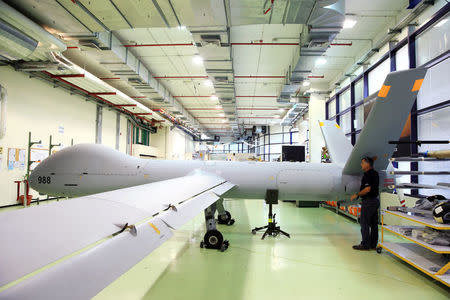 An employee stands next to an Elbit Systems Ltd. Hermes 900 unmanned aerial vehicle (UAV) at the company's drone factory in Rehovot, Israel, June 28, 2018. REUTERS/Orel Cohen