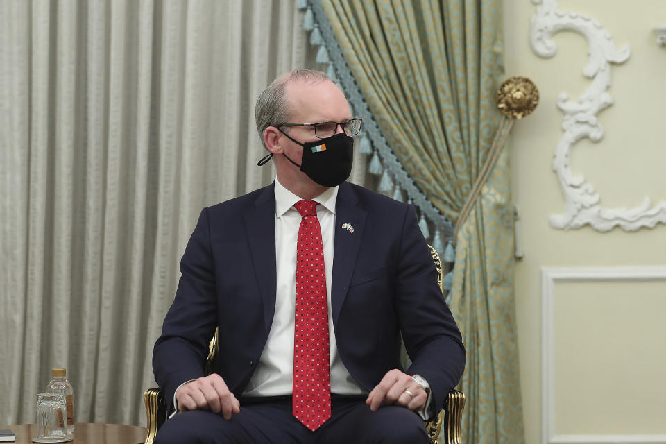 In this photo released by the official website of the office of the Iranian Presidency, Irish Foreign Minister Simon Coveney meets with President Hassan Rouhani, in Tehran, Iran, Sunday, March 7, 2021. (Iranian Presidency Office via AP)