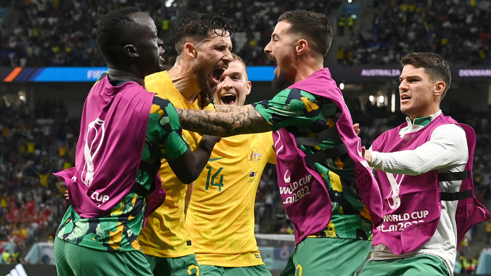 The Socceroos celebrate around Mathew Leckie after his goal against Denmark at the FIFA World Cup.