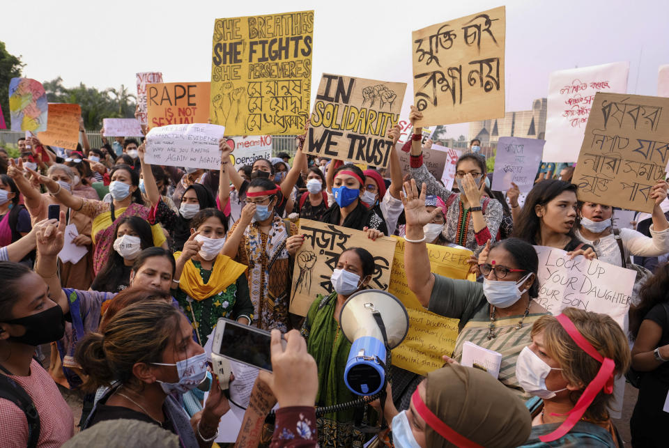 Women’s rights activists and others protesting against gender based violence hold placards outside the Parliament in Dhaka, Bangladesh, Friday, Oct.9, 2020. Bangladesh's Cabinet has approved an increase in the maximum punishment in rape cases to death from life imprisonment after a series of recent sexual assaults triggered protests. (AP Photo/ Mahmud Hossain Opu)