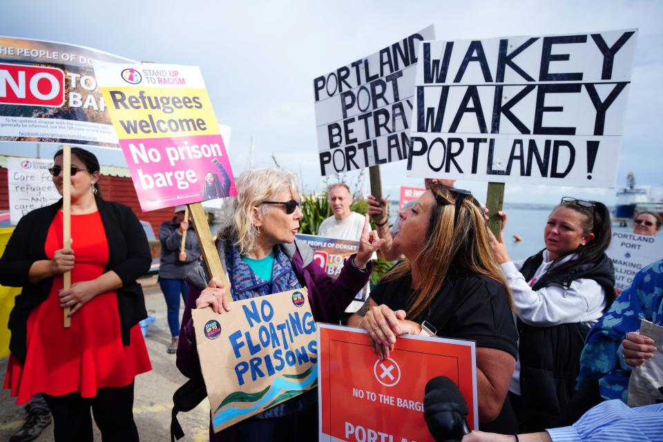 Rival protesters argue in Portland in Dorset after the Bibby Stockholm accommodation barge arrived from dry dock in Falmouth, Cornwall, where it is due to house migrants. Picture date: Tuesday July 18, 2023.