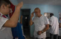 A man salutes after casting his vote at a polling station during the new Family Code referendum in Havana, Cuba, Sunday, Sept. 25, 2022. (AP Photo/Ramon Espinosa)