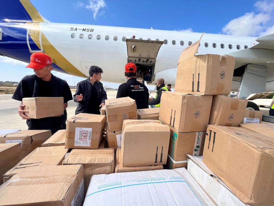 PHOTO: Members of Libya's Youth Hostels Association unload medical aid that arrived by plane at al Abraq airport, after a powerful storm and heavy rainfall hit Libya, in Al Abraq, Libya, Sept. 12, 2023. (Ayman Al-Sahili/Reuters)