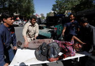 <p>Men move an injured man to a hospital after a blast in Kabul, Afghanistan May 31, 2017. (Mohammad Ismail/Reuters) </p>