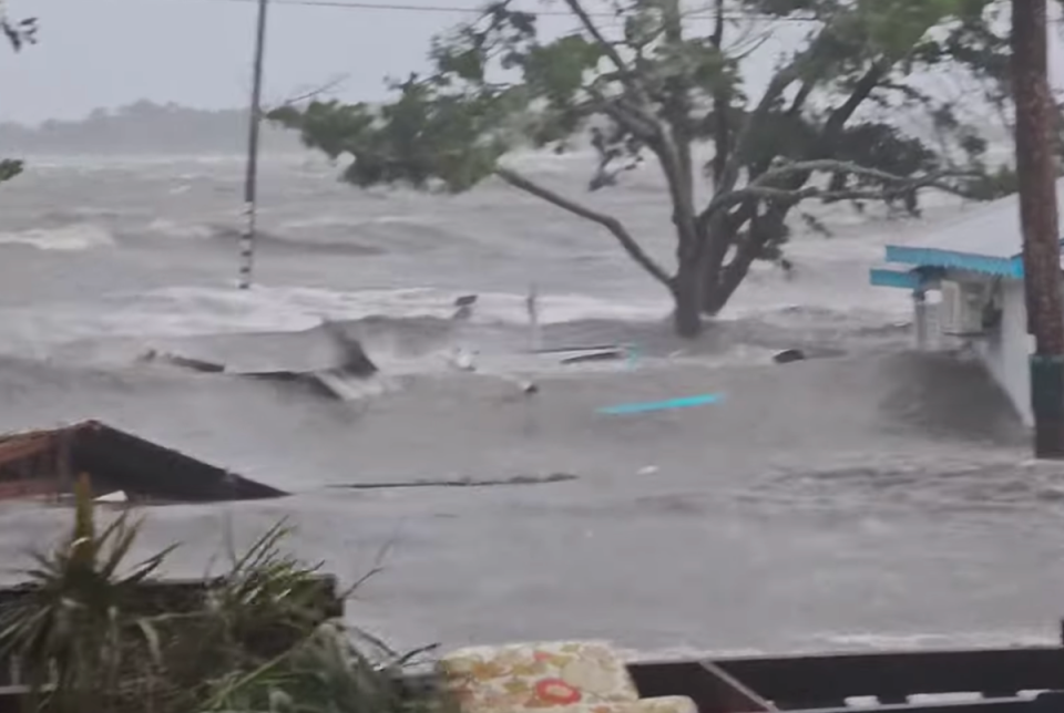 Waves were lapping up the roof lines of single story homes on Cedar Key Island after Hurricane Idalia made landfall on Wednesday with powerful winds and storm surge (Screengrab/Facebook/Michael Presley Bobbitt)