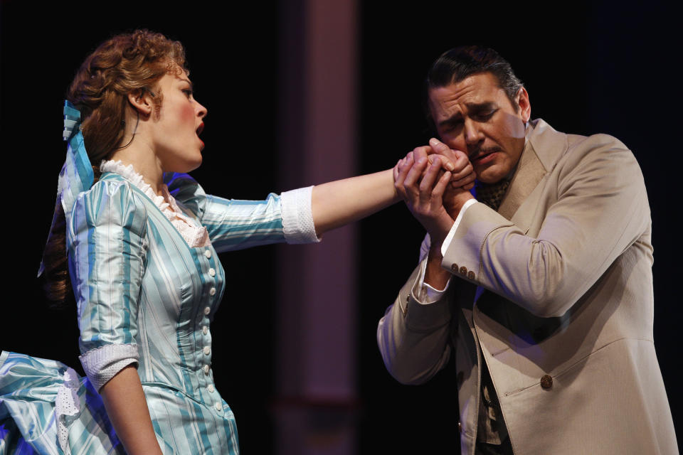 In this photo taken Feb. 9, 2012, Ashley Brown, left, portraying Magnolia Hawkes, and, Nathan Gunn, portraying Gaylord Ravenal, perform together at a dress rehearsal during the first act of the Lyric Opera of Chicago's production of "Show Boat." (AP Photo/M. Spencer Green)