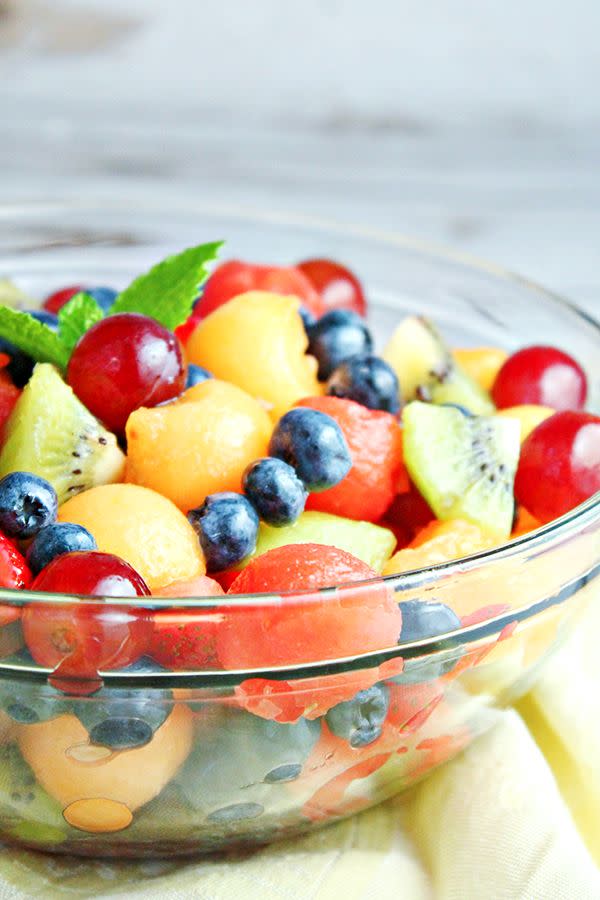 <p>For a simple and fresh vegan side, toss together this fruit salad. It may look like your standard recipe, but don't be fooled: This one stands out, thanks to a rum-based mint dressing that tastes a lot like a true mojito. </p><p><a href="https://homecookingmemories.com/easy-mojito-fruit-salad-recipe/" rel="nofollow noopener" target="_blank" data-ylk="slk:Get the recipe." class="link ">Get the recipe. </a></p>