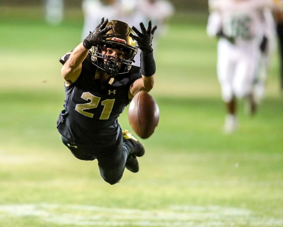 Xavier Prep's Tyson Ruiz (21) dives for a pass just out of reach during the third quarter of their second-round playoff game at Xavier College Preparatory High School in Palm Desert, Calif., Friday, Nov. 10, 2023.
