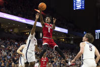 North Carolina State's Terquavion Smith (0) shoots between Virginia's Reece Beekman (2) and Ben Vander Plas (5) during the first half of an NCAA college basketball game in Charlottesville, Va., Tuesday, Feb. 7, 2023. (AP Photo/Mike Kropf)