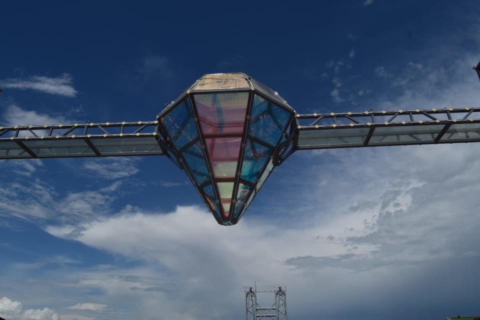 a glass bridge and diamond-shaped bar in the middle, suspended over the Dashbashi Canyon in Georgia