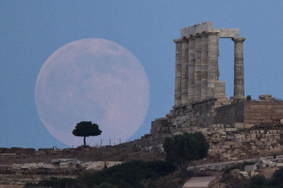 <p> FILE - In this June 20, 2016 file photo, the full moon rises behind a tree next to the ruins of the ancient marble Temple of Poseidon, built in 444 BC, at Cape Sounion, southeast of Athens, on the eve of the summer solstice. On Wednesday, Jan. 11, 2017, a California-led research team reported that the moon formed within 60 million years of the birth of the solar system. Previous estimates ranged within 100 million years, all the way out to 200 million years of the solar system’s creation. (AP Photo/Petros Giannakouris) </p>