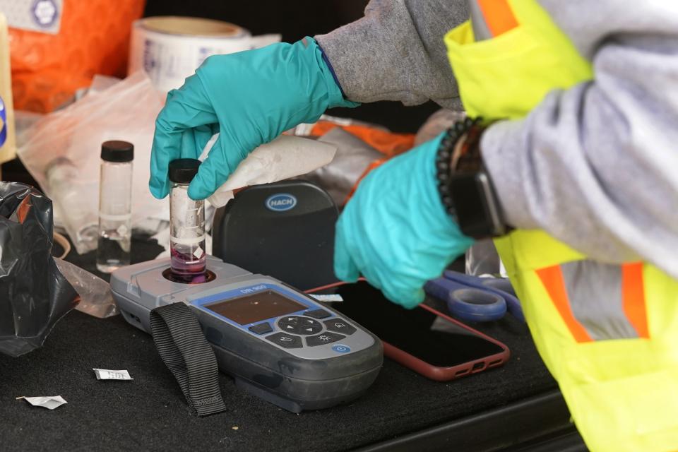 FILE - Water engineer Adrienne Conigliaro checks a water sampling at a home in Royal Oak, Mich., on Tuesday, Nov. 16, 2021. The Environmental Protection Agency will soon strengthen lead in drinking water regulations. (AP Photo/Carlos Osorio, File)