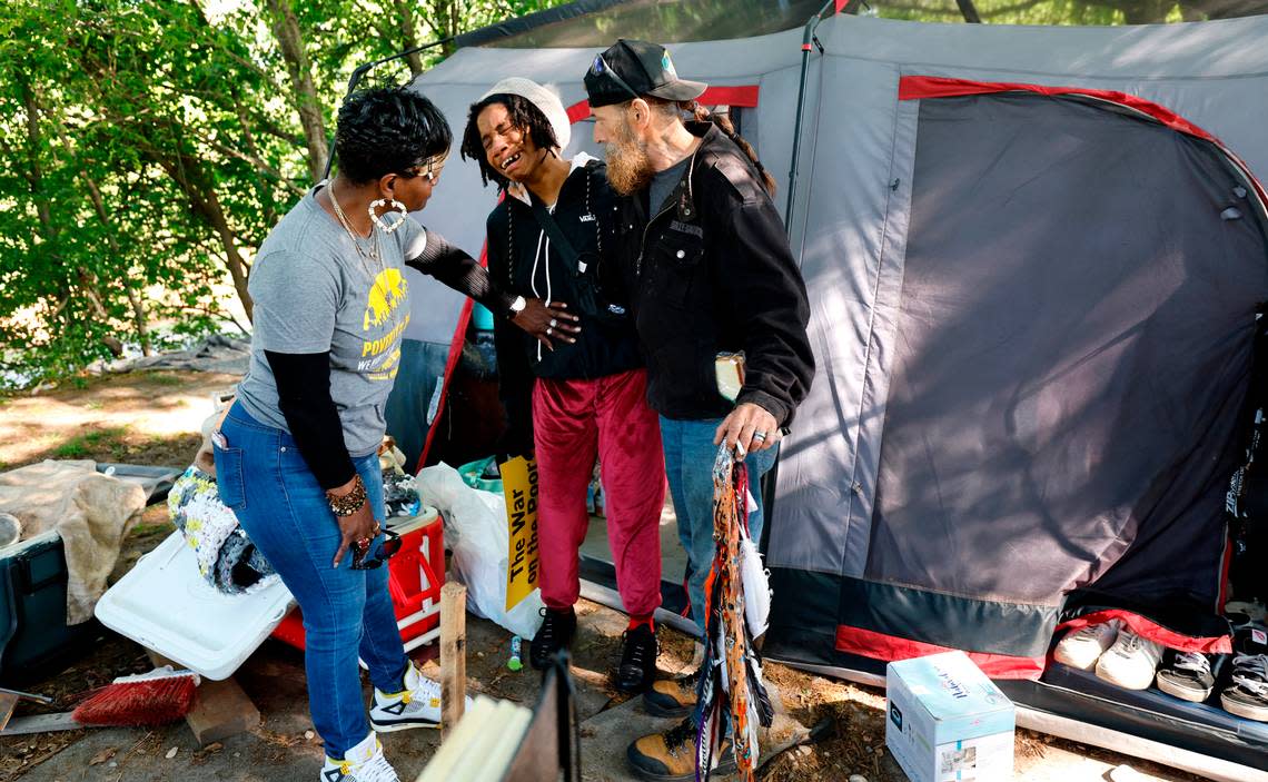 Sangria Noble and ‘Wild Horse’ comfort Brandy as they start to pack up the “Welcome to Garner” tent community in Garner, N.C., Tuesday, April 23, 2024. Brandy who is seven months pregnant has lived in the encampment for six months.