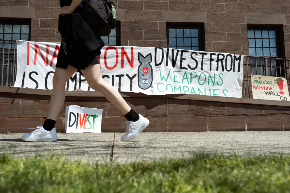  Multiple banners on Wesleyan’s encampment advocated for divestment from weapons manufacturers. (Shahrzad Rasekh/CT Mirror)