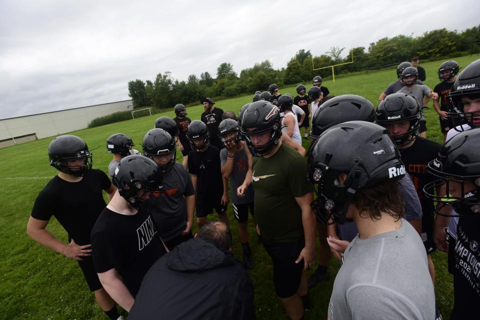 The Marine City football team huddles together during first practice of the season at Marine City High School on Monday, August 8, 2022.