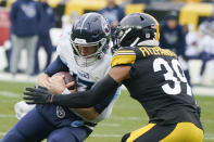 Tennessee Titans quarterback Ryan Tannehill (17) is hit by Pittsburgh Steelers free safety Minkah Fitzpatrick (39) after a scramble during the first half of an NFL football game, Sunday, Dec. 19, 2021, in Pittsburgh. (AP Photo/Gene J. Puskar)