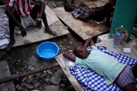 A boy receives treatment for cholera after Hurricane Matthew in the Hospital of Port-a-Piment, Haiti, October 9, 2016. REUTERS/Andres Martinez Casares