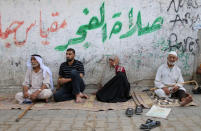 Palestinians sit outside their houses at Khan Younis refugee camp in the southern Gaza Strip September 10, 2018. REUTERS/Ibraheem Abu Mustafa