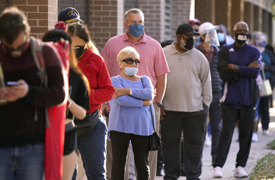 Voters line up outside Richardson City Hall for early voting Tuesday, Oct. 13, 2020, in Richardson, Texas. (AP Photo/LM Otero)