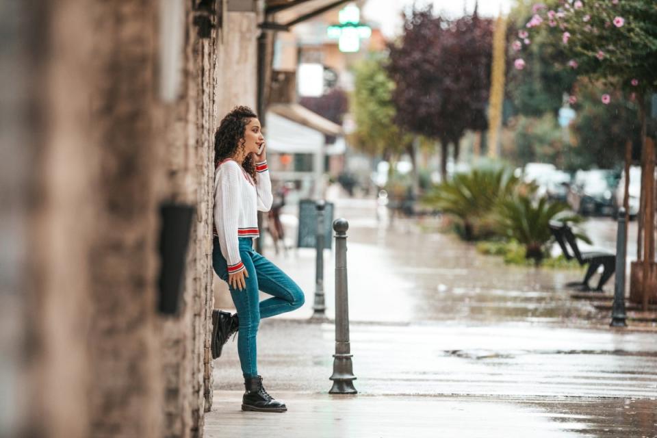 Girl leaning on concrete wall