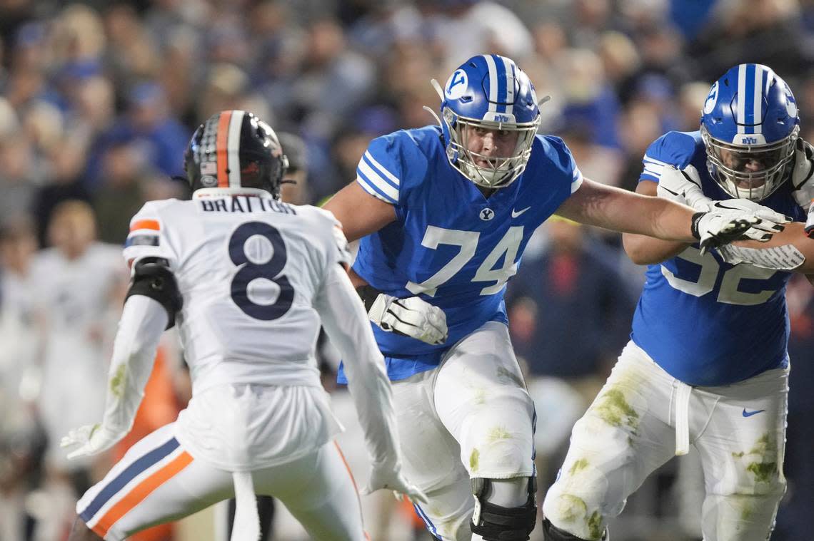 BYU offensive lineman Campbell Barrington (74) looks to block Virginia cornerback Darrius Bratton (8) in the second half during an NCAA college football game Saturday, Oct. 30, 2021, in Provo, Utah. (AP Photo/George Frey)