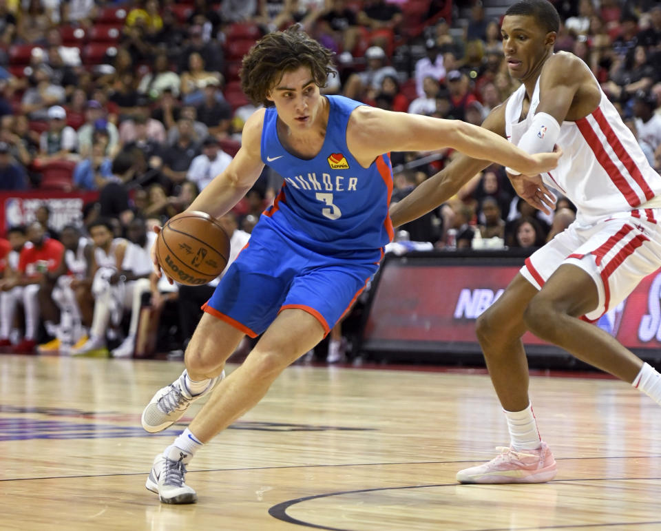 Oklahoma City Thunder's Josh Giddey (3) drives the ball against Houston Rockets' Jabari Smith II during the second half of an NBA summer league basketball game Saturday, July 9, 2022, in Las Vegas. (AP Photo/David Becker)