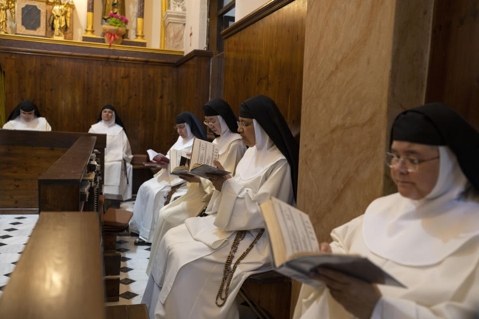 From left to right, Sister María Guadalupe, Sister María Esclava, Sister María de Jesús, Sister María de la Trinidad, Sister María Fatima, and Sister Amparo de María pray in the Catholic Monastery of St. Catherine on the Greek island of Santorini on Tuesday, June 14, 2022. The nuns pray at least nine hours a day, most of it sung in Latin, Spanish and Greek. (AP Photo/Petros Giannakouris)