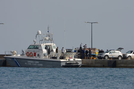 Hellenic Coast Guard officers and locals transfer the bodies of migrants that were drowned when the small boat they were travelling on capsized near the island of Agathonisi, at the port of Pythagoreio on the island of Samos, Greece, March 17, 2018. SamosTimes.gr via REUTERS