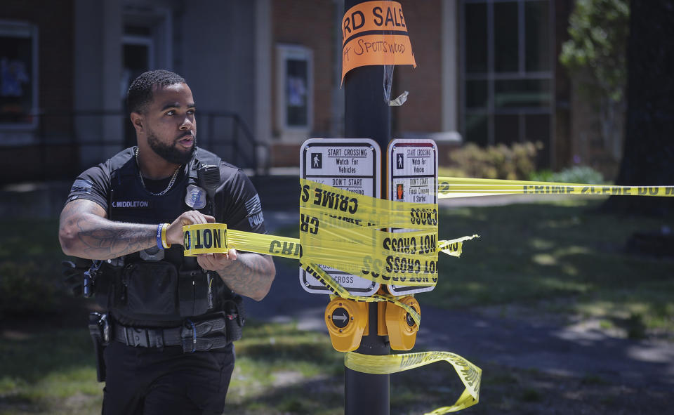 Memphis Police officers extend the crime scene tape around the perimeter of an active shooter situation near the University of Memphis, Tuesday, May 2, 2023. (Patrick Lantrip/The Daily Memphian via AP)