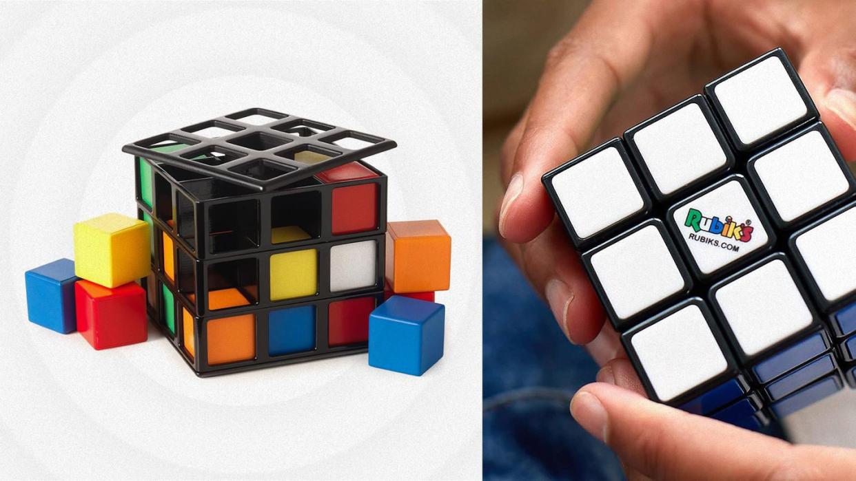 a person holding a rubiks cube