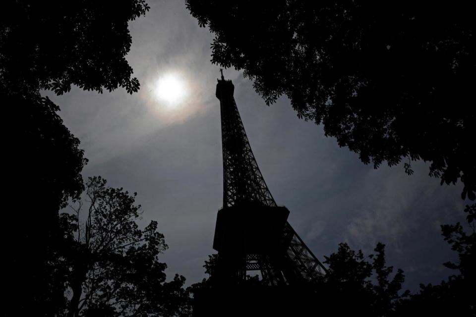 The sun shines in the sky over the Eiffel Tower in Paris (REUTERS)