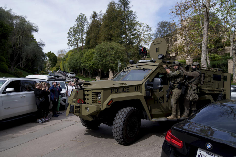 Law enforcement rides a vehicle near a property belonging to Sean "Diddy" Combs on Monday, March 25, 2024, in Los Angeles. Two properties belonging to Combs in Los Angeles and Miami were searched Monday by federal Homeland Security Investigations agents and other law enforcement as part of an ongoing sex trafficking investigation by federal authorities in New York, two law enforcement officials told The Associated Press. (AP Photo/Eric Thayer)