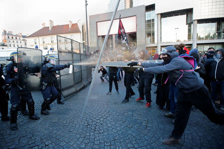 French riot police clash with demonstrators after early results in the first round of 2017 French presidential election, in Paris, France April 23, 2017. REUTERS/Jean-Paul Pellisier