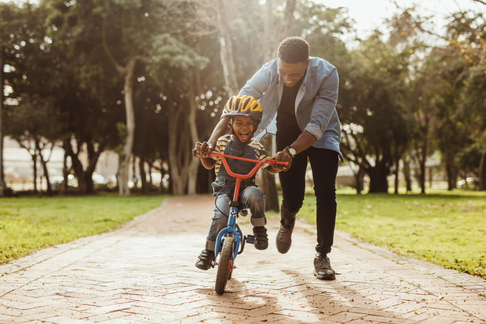 Father teaches son to ride a bike