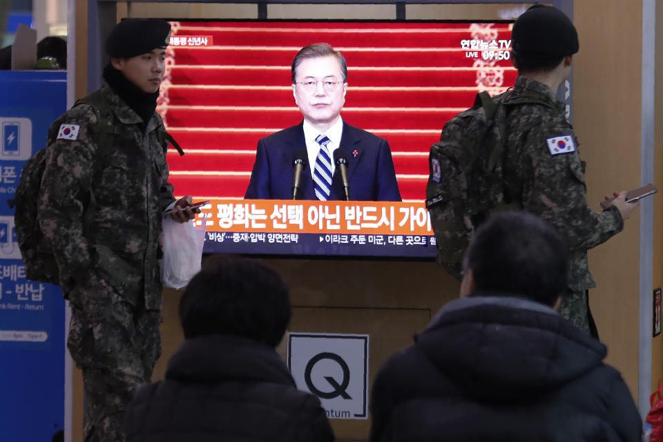 South Korean army soldiers pass by a TV screen showing the live broadcast of South Korean President Moon Jae-in's New Year's speech at the Seoul Railway Station in Seoul, South Korea, Tuesday, Jan. 7, 2020. Moon said he hopes to see North Korean leader Kim Jong Un fulfill a promise to visit the South this year as he called for the rival Koreas to end a prolonged freeze in bilateral relations. (AP Photo/Ahn Young-joon)