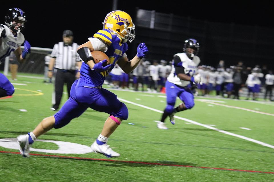 Hull's John Gianibas runs up the sideline against Randolph at Hull High School on Friday, Oct. 1, 2021.