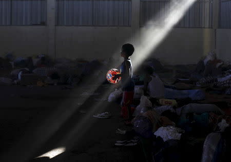 A Rohingya boy, who recently arrived in Indonesia by boat, holds his ball as he walks at a shelter in Kuala Langsa, in Indonesia's Aceh Province, May 19, 2015. REUTERS/Beawiharta