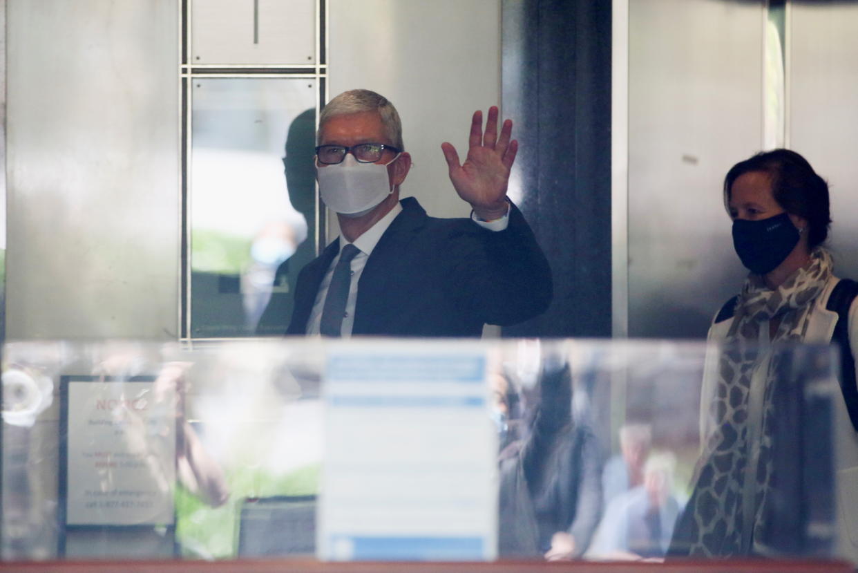 Apple CEO Tim Cook waves from the elevator as he leaves after speaking during a weeks-long antitrust trial at federal court in Oakland, California, U.S. May 21, 2021.  REUTERS/Brittany Hosea-Small