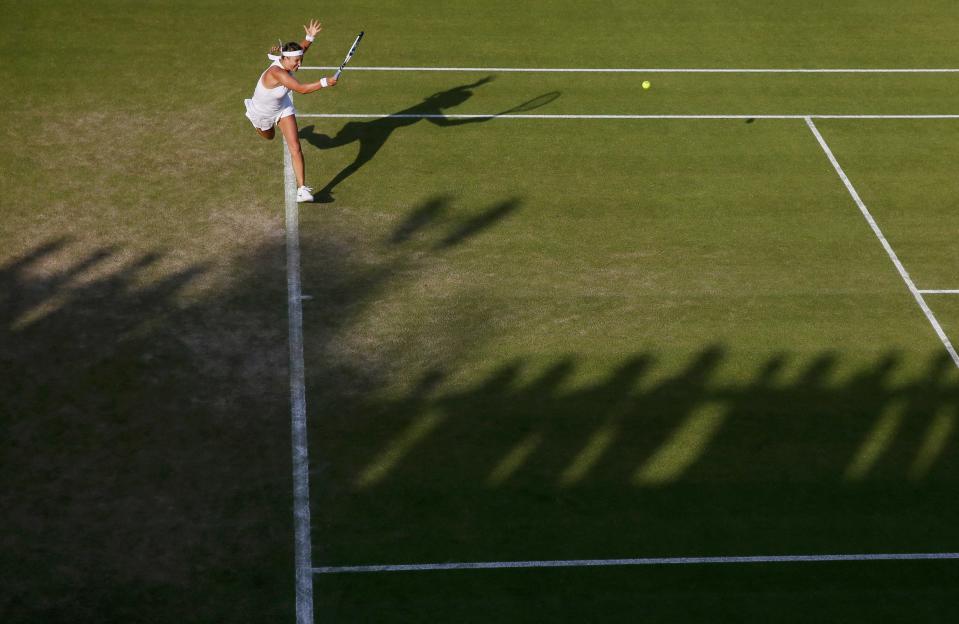 Victoria Azarenka of Belarus hits a shot during her match against Kirsten Flipkens of Belgium at the Wimbledon Tennis Championships in London, July 1, 2015. REUTERS/Stefan Wermuth